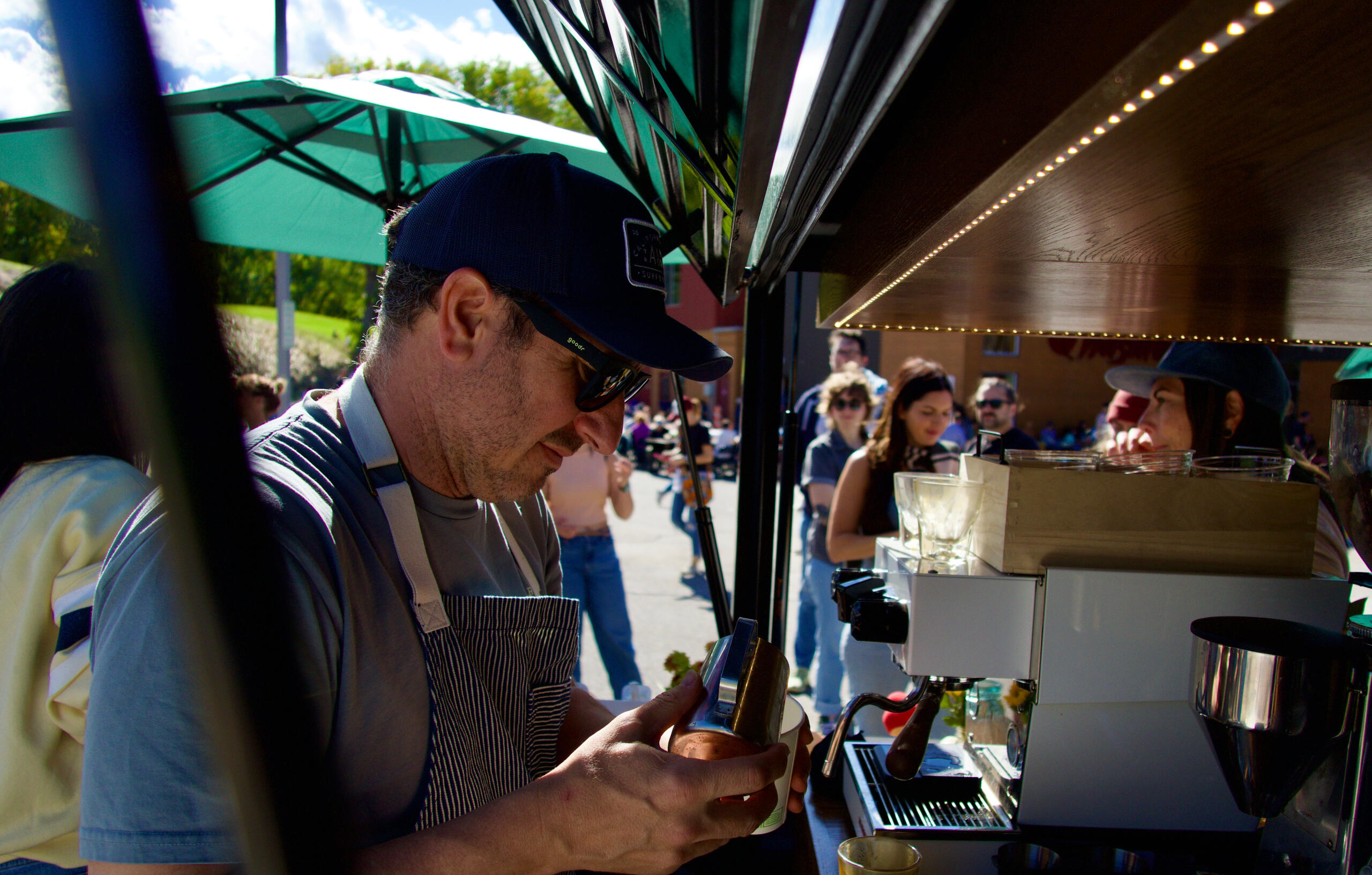 Serving espresso drinks from the back of the Piaggio Ape. Tony D'Amico serving up some espresso on the back on the Piaggo Ape at a Pop Up event.